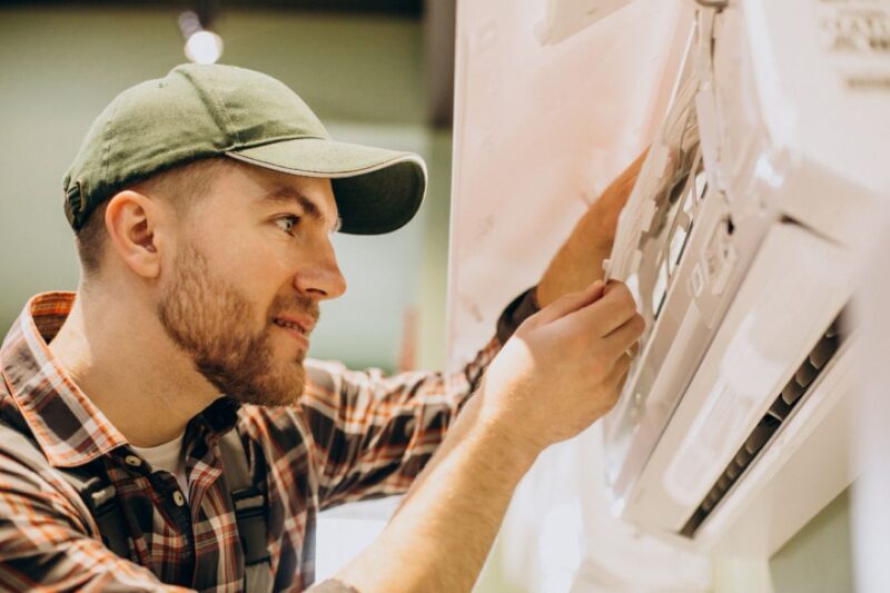 Ac Maintenance Guide: How Can You Keep Your Air Conditioner Running Like New 2 Technician inspecting a split AC indoor unit in a Nepali home